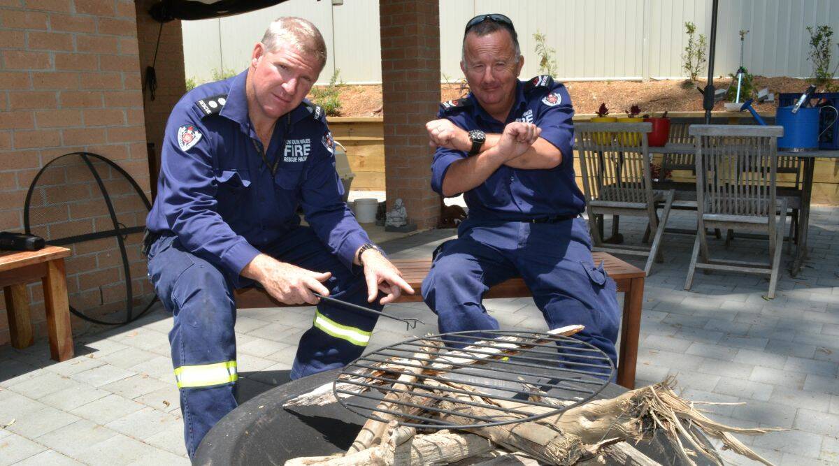 NOT ALLOWED: Batemans Bay Fire and Rescue station officer Phillip Eberle and qualified firefighter Mark Gordon stress that lighting a wood fire barbecue during a total fire ban is not allowed.