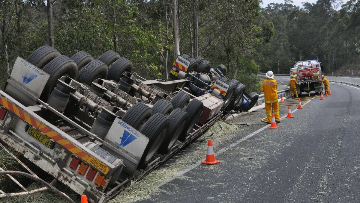 HAY BALE MAYHEM: The scene Monday afternoon after a truck lost control on a bend and tipped over south of Batemans Bay.