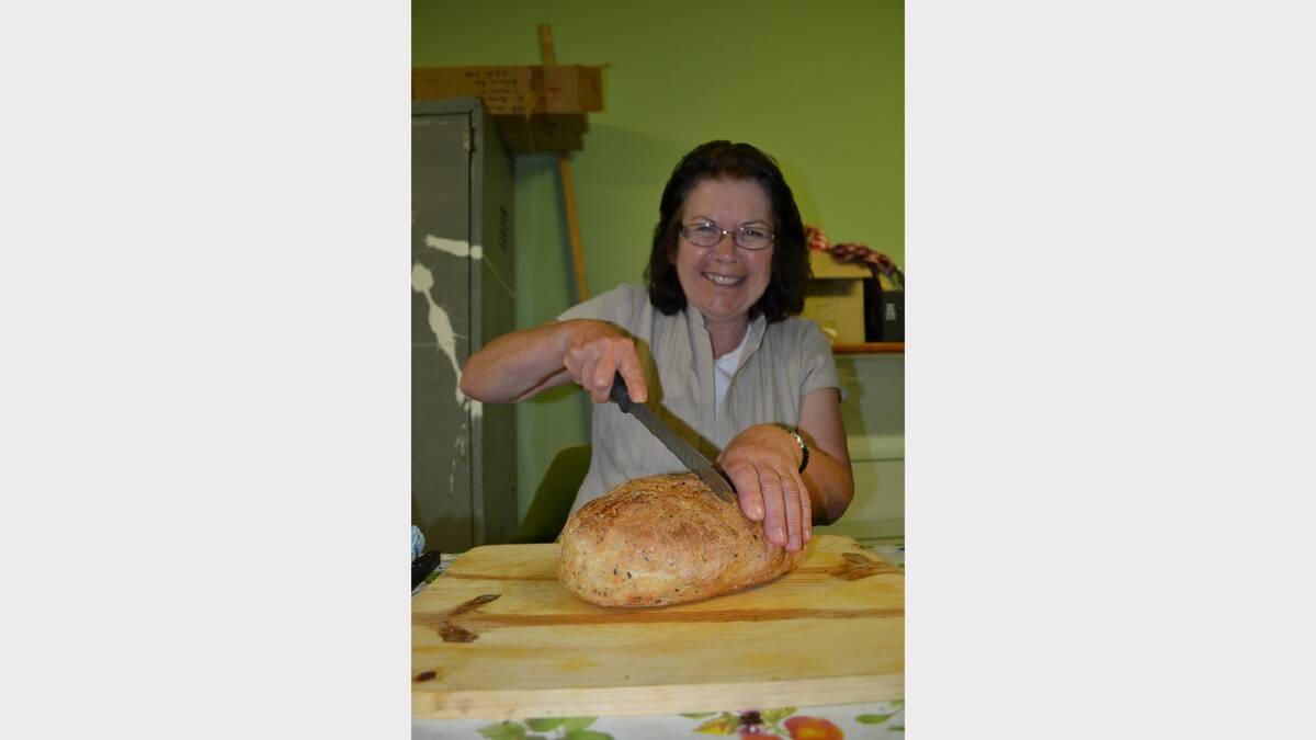 KNIFE EDGE: Janette Allen takes a blade to a beautifully baked loaf as judging gets underway in the pavilion.