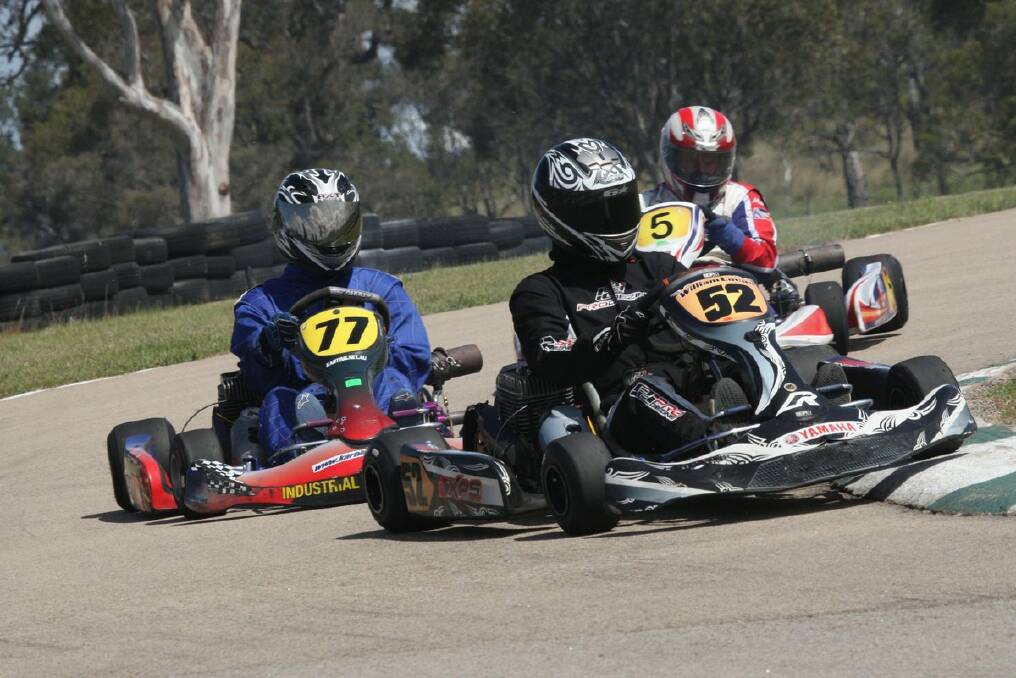 BURNING RUBBER: William Lucas first in kart 52, with Mitchell Gatenby (kart 77) in second place and Ian Crawford (kart 5) competing in the clubman light class. PHOTOS: Coopers Photography.