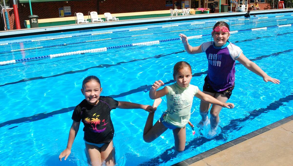 WALKING ON WATER: Ella and Ava-Lily Mauger, from Surf Beach, and Elissa Tilyard, from Queanbeyan, splashing around at Batemans Bay pool.