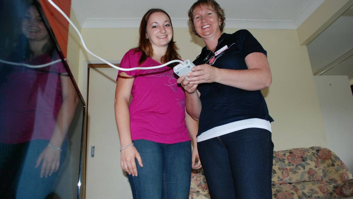 KILL BILL: Salvation Army Batemans Bay HESS worker Kylie Cursio (right) gives Malua Bay’s Kirsty Rendell the lowdown on her television’s power consumption.