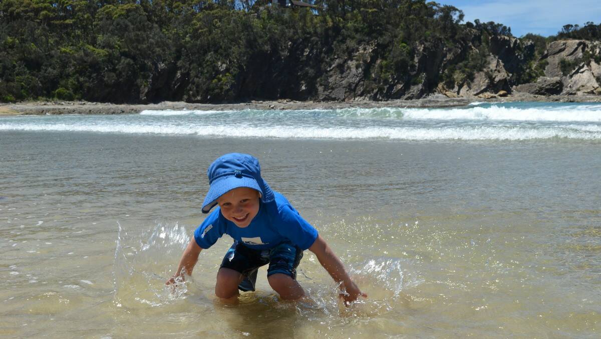 BEACH TIME: Kobe Wood, from Canberra, makes the most of his visit to the South Coast, splashing around McKenzies Beach.