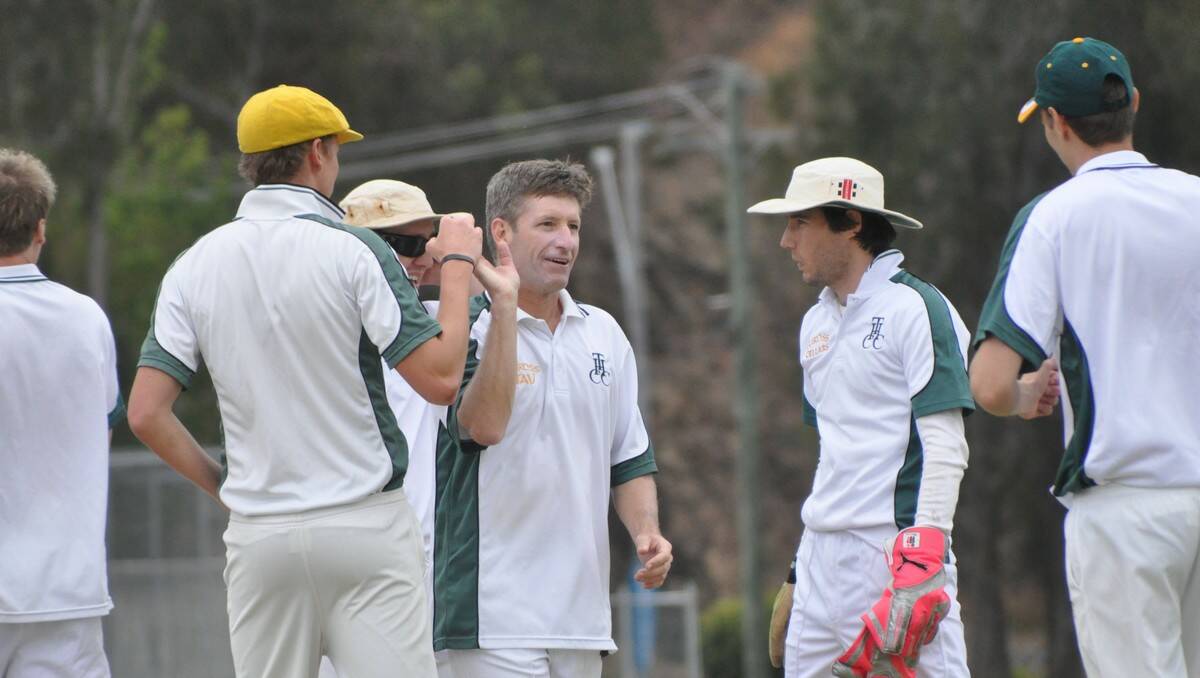 HIGH FIVE: Les Roberts-Thompson (middle, left) and Tim Hartshorn (middle, right) celebrate a wicket for Tuross Head. PHOTO: Dean Benson.
