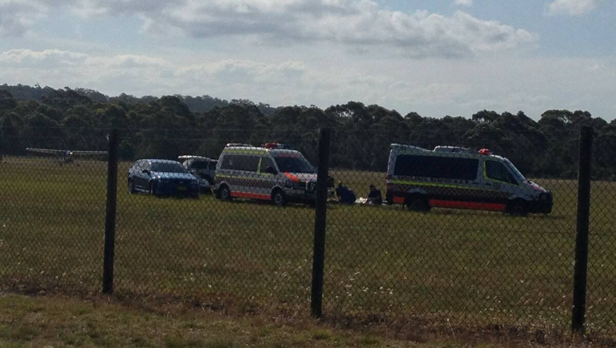 ACCIDENT SCENE: Paramedics attend to a skydiver at Moruya airport.