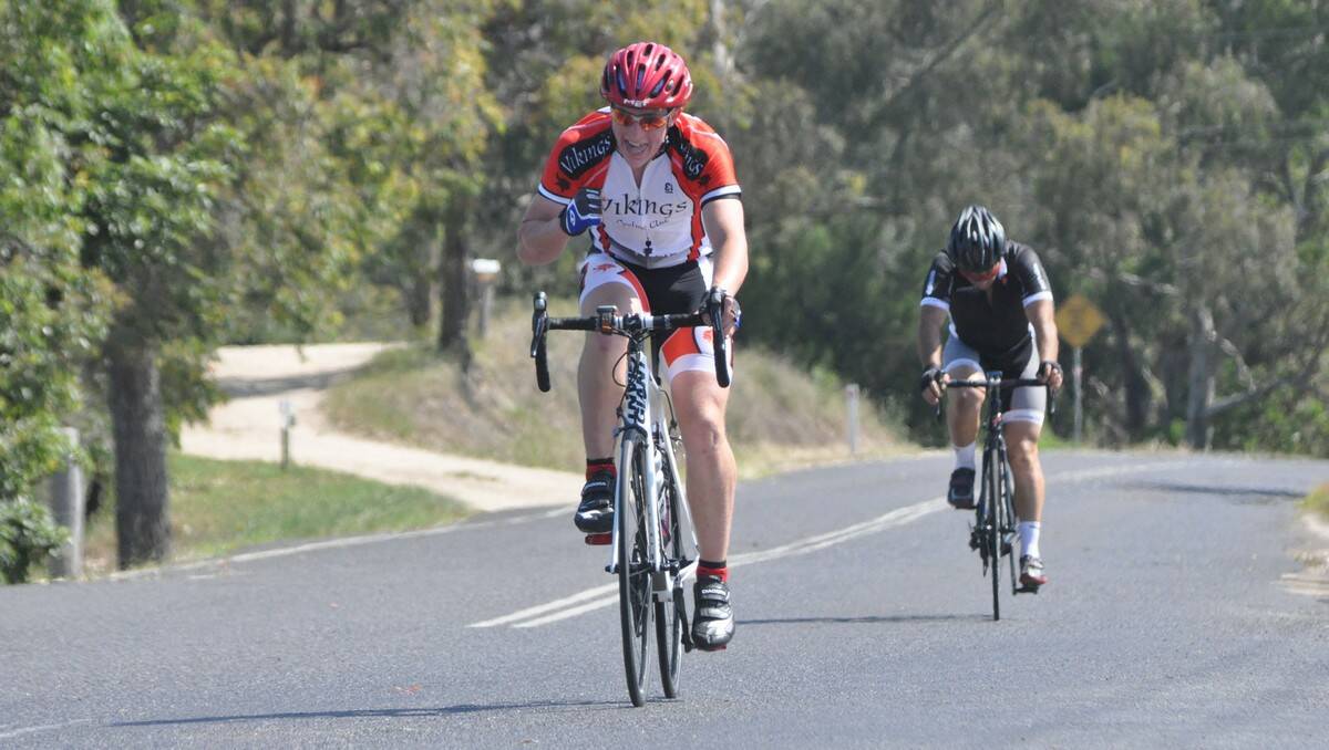 WHAT A WIN: Moruya road race winner Sam Moorby celebrates at the winning line after beating Con Toparis (background) in a sprint finish. PHOTO: Dean Benson.