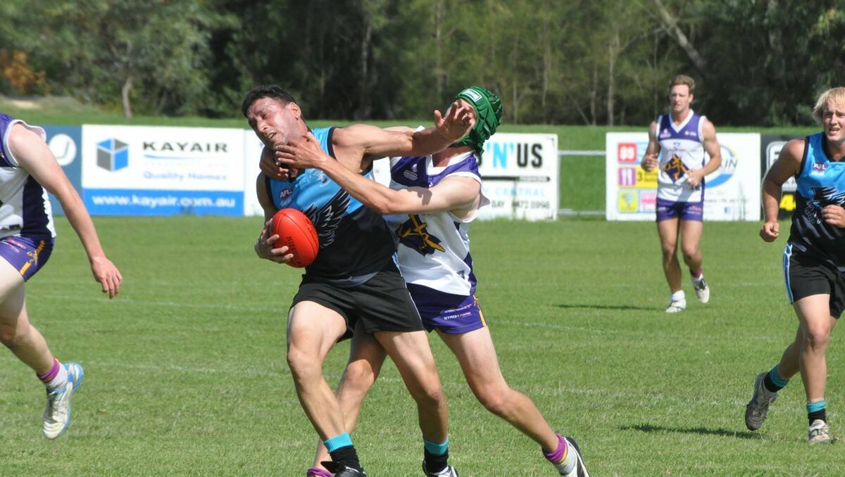 CRUNCH TIME: Bay Seahawks player Dan Tuan (left) cops a big hit from	 Culcairn’s Scott Stoll during Saturday’s trial match at Hanging Rock Oval. 	PHOTO: Dean Benson.