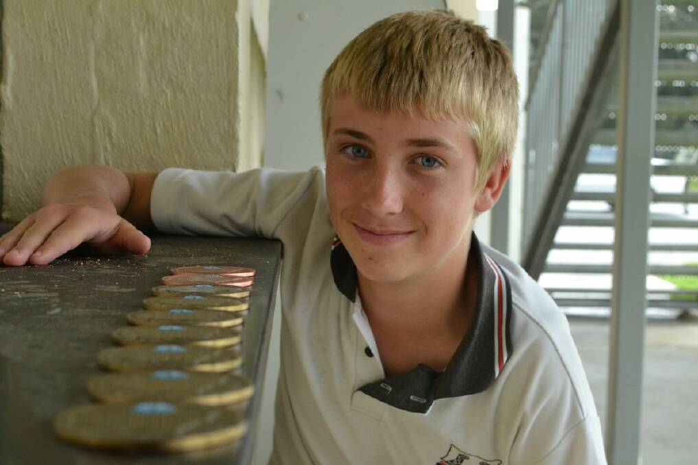 MEDAL TALLY: Nelligen youngster Shane Ison with the seven gold and two bronze medals he won at the weekend’s state shooting titles. PHOTO: Dean Benson.