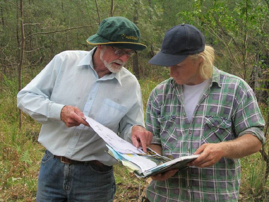  Keith Joliffe and volunteer Daniel Baumann check for eucalypt on a recent field survey as part of the Eurobodalla Koala Project.