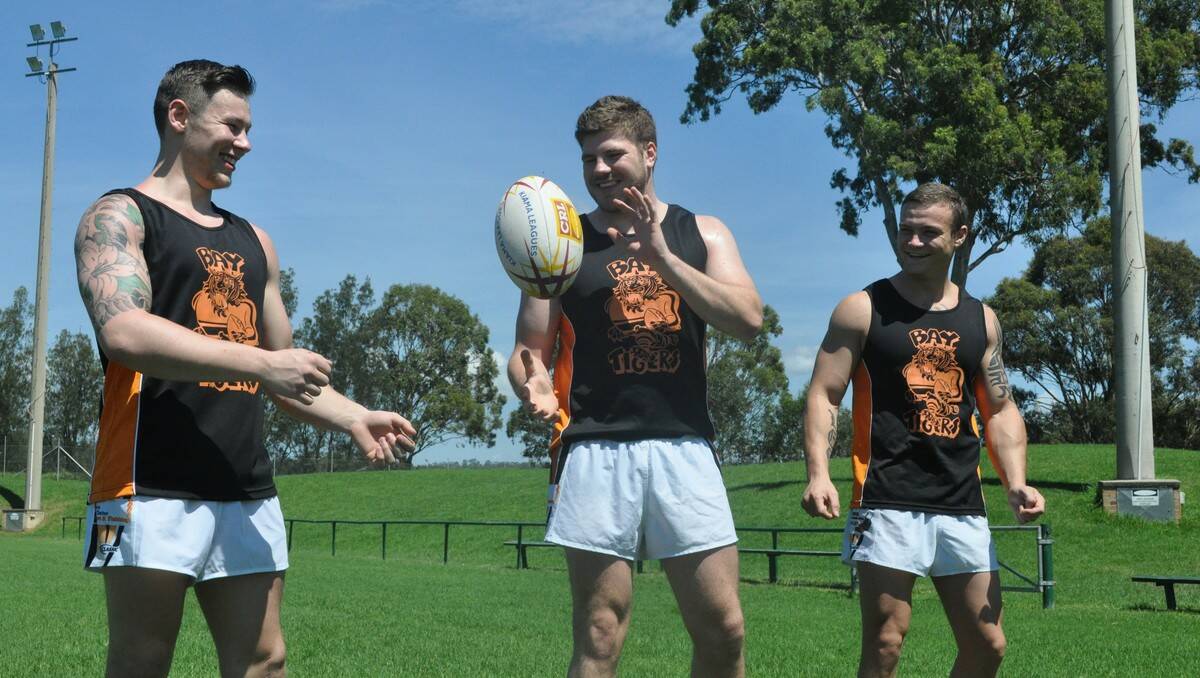 TIGER TALK: (From left) James Delaney, Sam Cunningham and Lee Atherton at Mackay Park on Monday. PHOTOS: Dean Benson.