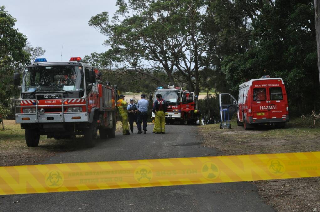 SCARY MOMENT: Police and Rural Fire Service officers await an Army Ordinates Unit at Mossy Point after discovering an unexploded navy device.
