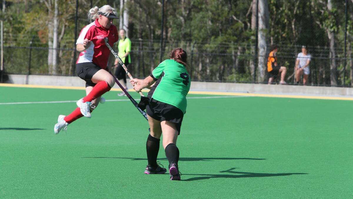 SHOALHAVEN: St Georges Basin’s Kellie McIlwain gets caught in an awkward position mid-air by Allsorts Green’s Mel Boundy in Allsorts’   3-1 win on Saturday. Photos: ROB CRAWFORD