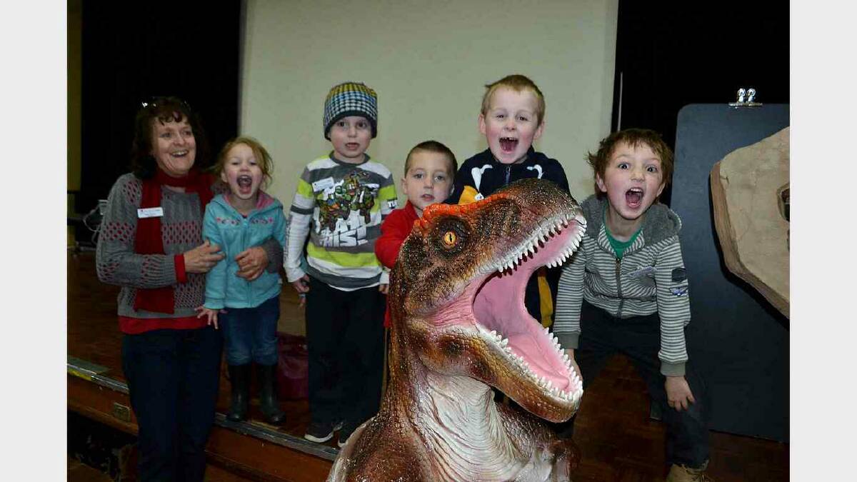 EDEN: Marg Carson of Bega Valley Family Day Care  had her hands full with little palaeontologists  Halle Berk, Beau Towill, Callum Gallagher, Blake Bateman and Bailen Berk when the National Dinosaur Museum’s travelling road show came to Eden on Thursday