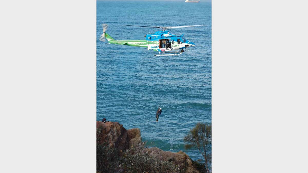 A high school student was winched from a cliff at Eden on Monday after he  became separated from a school excursion group.