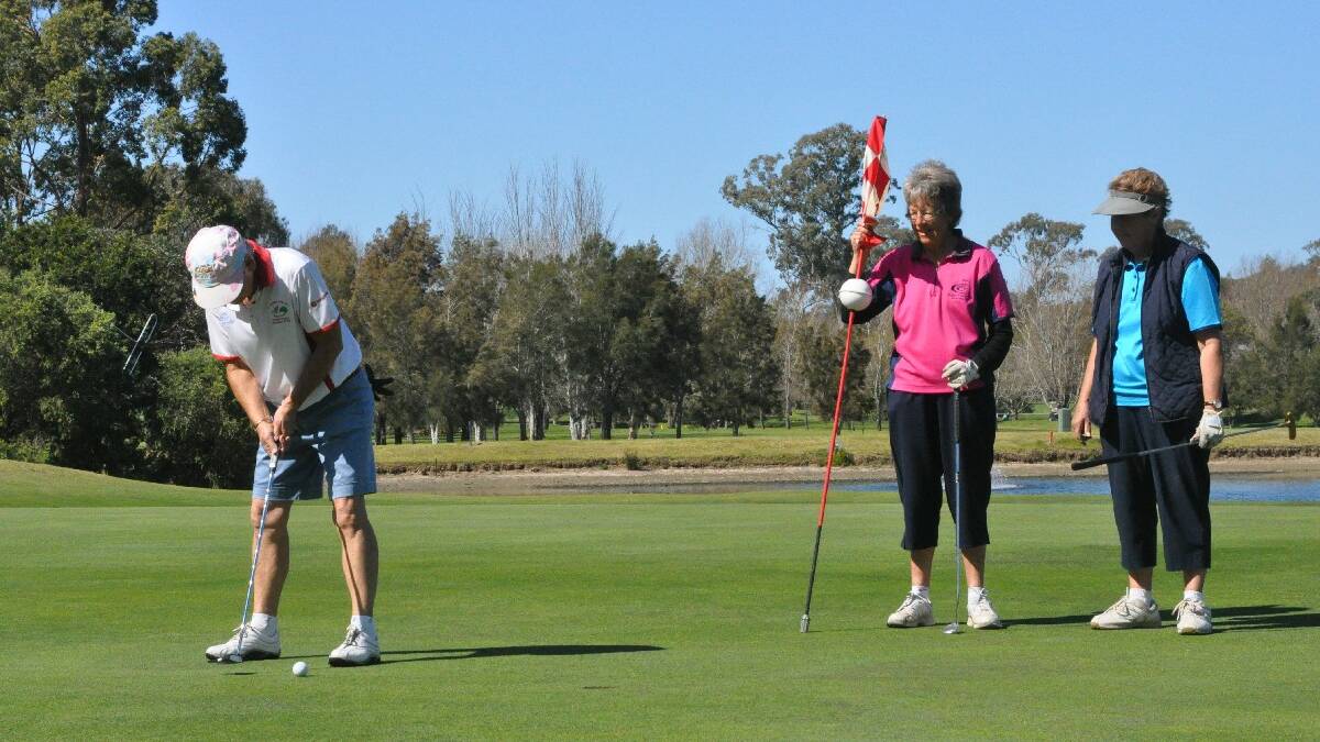  MORUYA: Jennifer Hartman putts while Helen Wise and Shirley Noy look on at the Moruya Ladies Golf Open on Sunday.