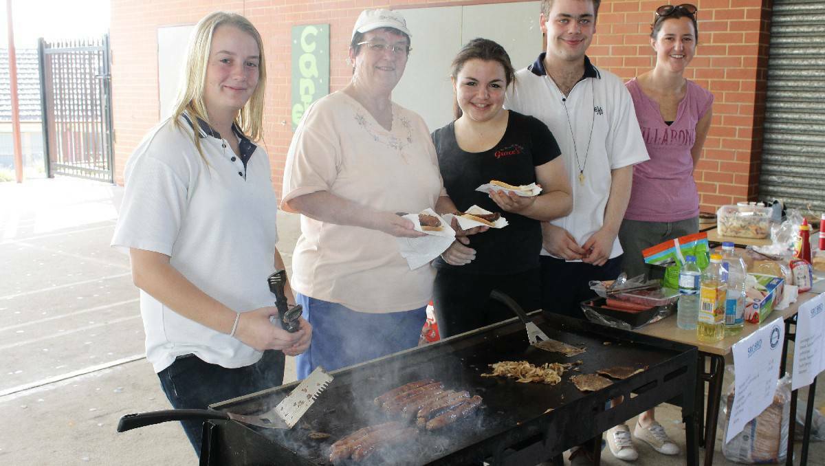 Manning the barbecue are Bega High School's (from left) Imogen Pittolo, Brenda Montgomery, Sarah Halin, Tas Fitzer and Sophie Scroope.