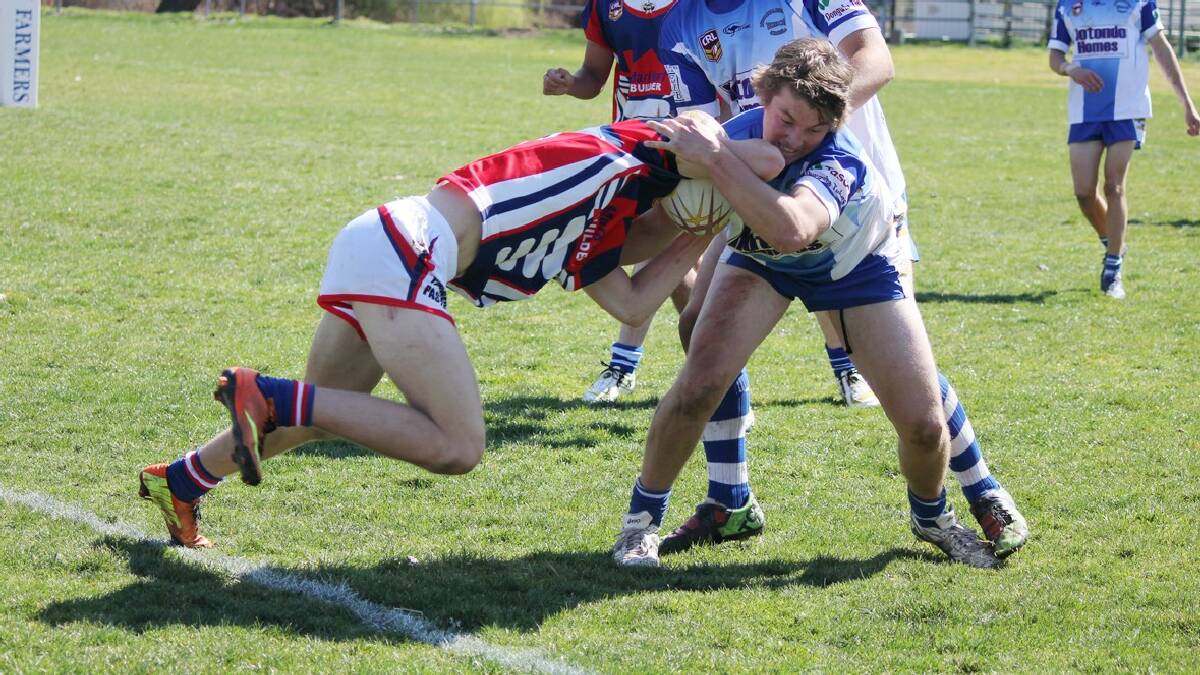 MERIMBULA: Bluedog Jarrod Dewberry throws a heavy tackle on his Roosters opponent on Sunday. 