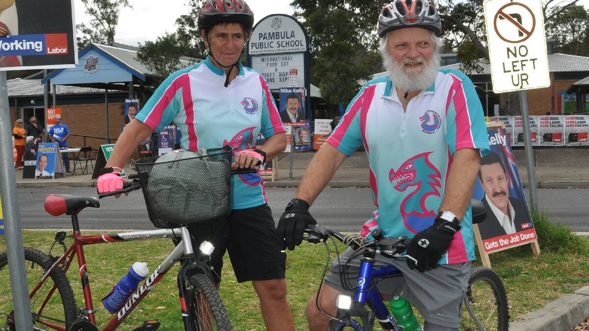 Pat and Charles Helmore, of the Sapphire Water Dragons dragon boat club on a bike ride to Pambula Public School as part of their exercise regime which on this occasion included voting too.
