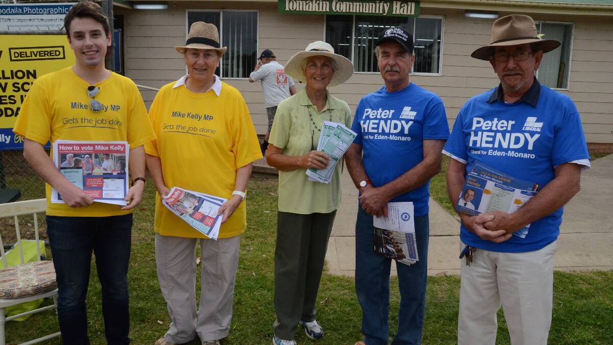 ALP supporters Michael Pettersson and Geraldine White, Greens supporter Jenny Edwards and Liberal Party supporters Peter Gordon and Bob Kolderie were handing out how to vote cards in Tomakin early this morning.