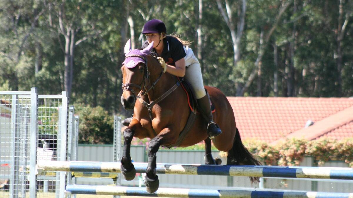  ULLADULLA: Keely Gambol of Woonoona takes her horse over a jump during competition at the Mollymook Pony Club.