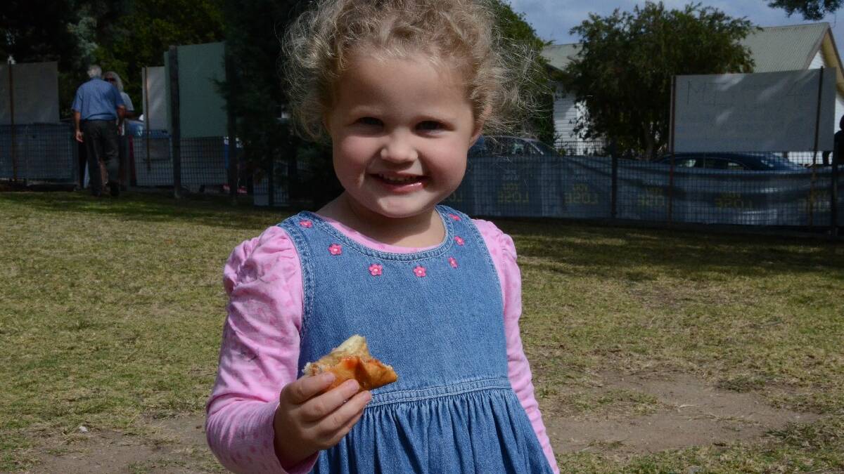 Alice Wassell, 3, of Tuross Head was enjoying her sausage sandwich at Moruya Public School this morning.