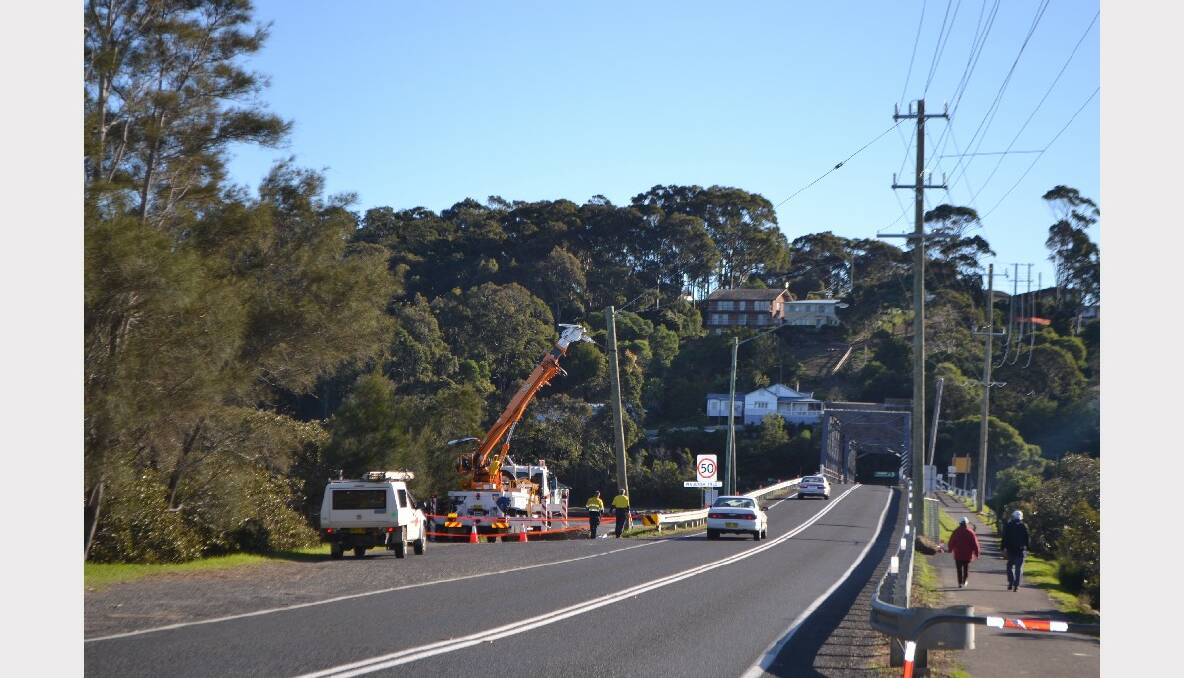 Essential Energy crews on Saturday temporarily stabilised the new but tilting power pole at the Narooma Bridge on Sunday using one of their trucks.