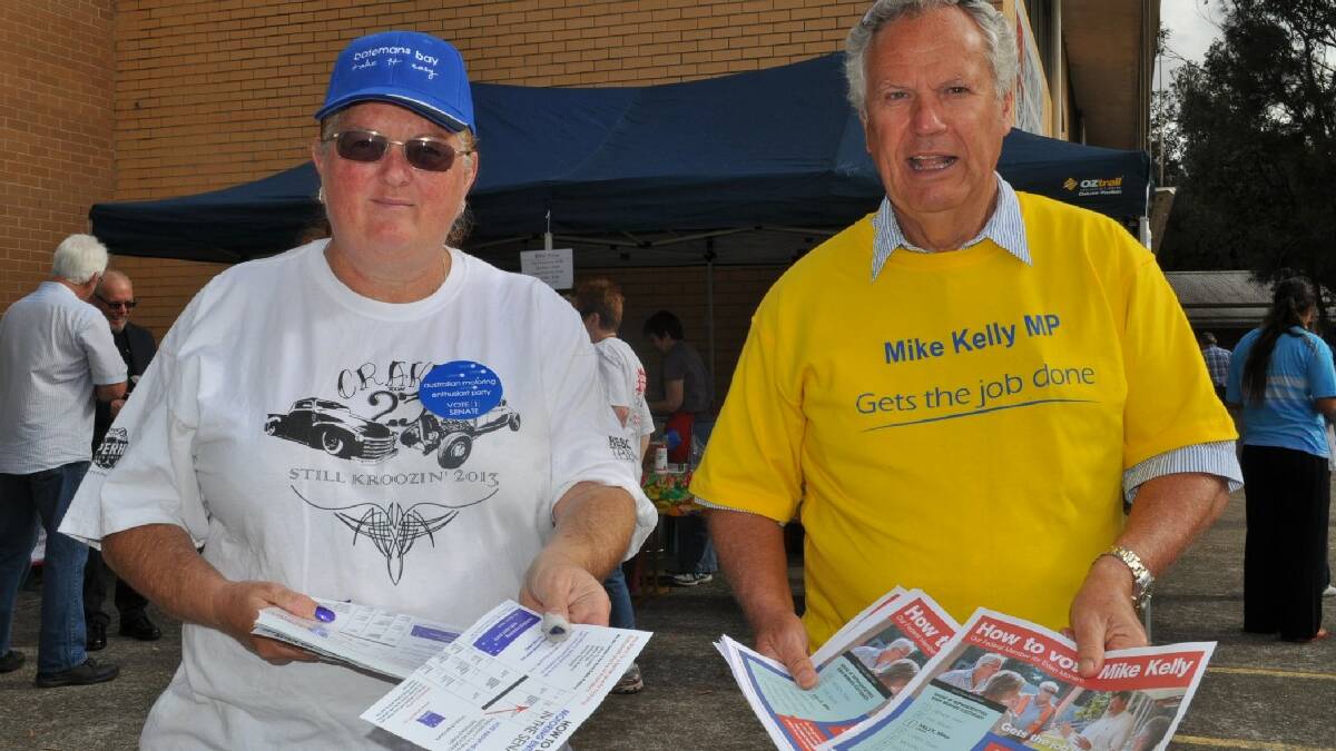 Anne-Marie Collins and Peter Coggan handing out how to vote cards at Batemans Bay High School.