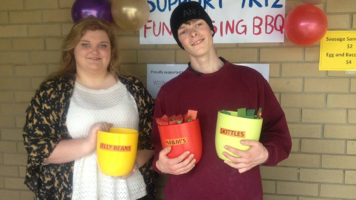 Eden Year 12 students Ainslea baumer and Andrew holka fundraise for their formal with lollies and a barbecue. 
