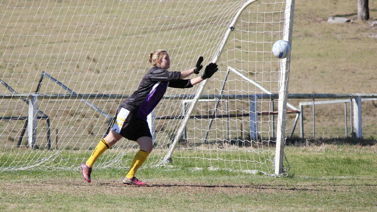 WOLUMLA: Tigress Caitlin Johnson fends off another attack from the Eden Killers Whales in Wolumla's win. Johnson was replacing injured keeper Kathy Brisbane. 