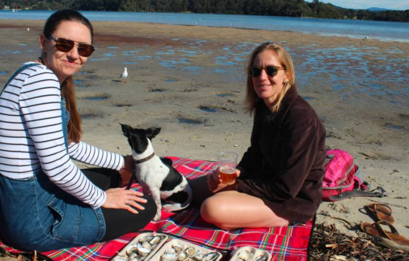 Oyster lovers from far and wide flock to the Narooma Oyster Festival. Tracy and Lisa from Jervis Bay enjoyed local oysters, beers and a picnic rug on the beach looking over Wagonga Inlet. Picture: James Tugwell.