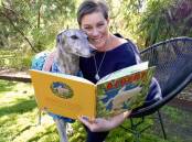 Kylie Miller with her adopted greyhound Teddy and her newest book Albert, the greyhound who loves to love. Photo: supplied 