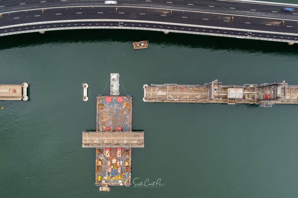 Drone footage shows the second span being removed via barge using a combination of the rising tide and cranes. Photo: South Coast Pix