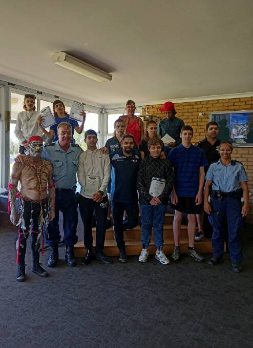 (Back row L-R) Talon Elliott, Chris Carriage, Holden Dunne, facilitator Di Robinson, Harry Rogan, Jamal Parsons and Adrian Andy from Grand Pacific Health. (Front row L-R) Yuin Elder Bindarray, Greg Curry, Nicholas Jessop, Youth worker Caine Brierely, Rusty Hogarth Bower, Kayden Rouse and Senior Constable Donna Clarke
