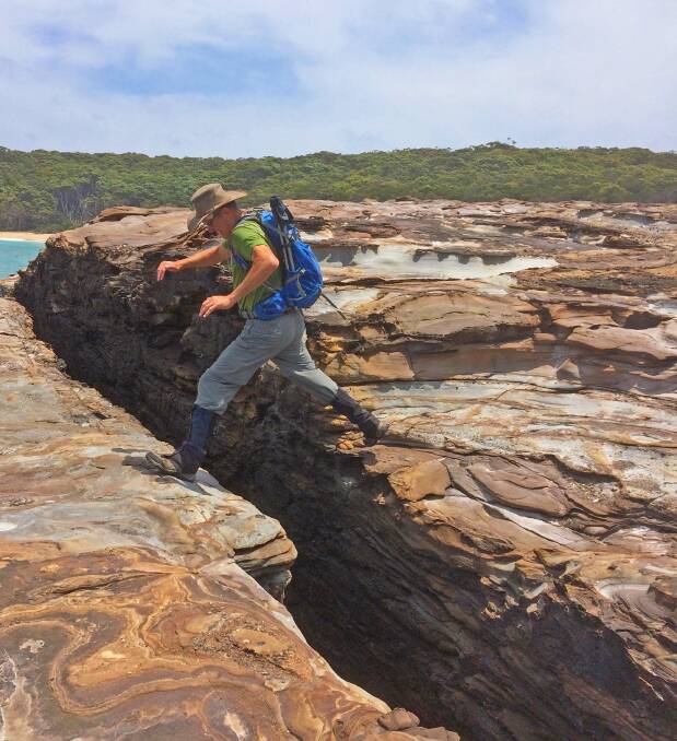 Rob takes the 'leap of faith', one of many interesting rock formations to see in Durras. Pciture: Batemans Bay Bushwalkers. 