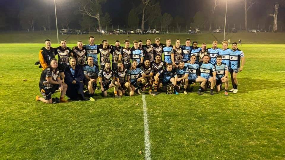 The Sharks and Tigers pose after the first-grade game.
