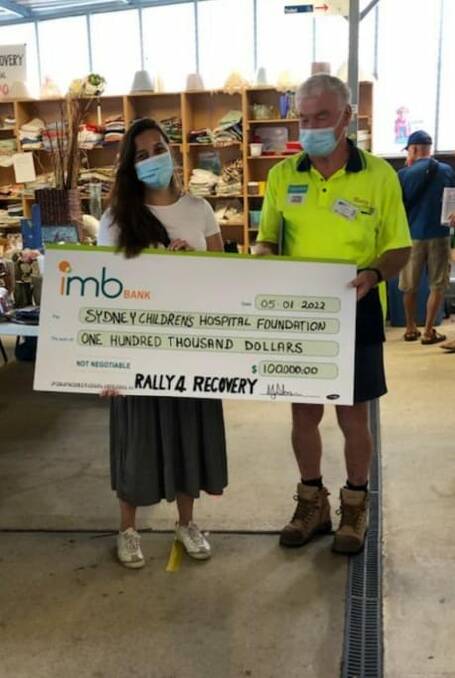 Ken Sloan presents a cheque to Jessica Theng of the Children's Cancer Centre.