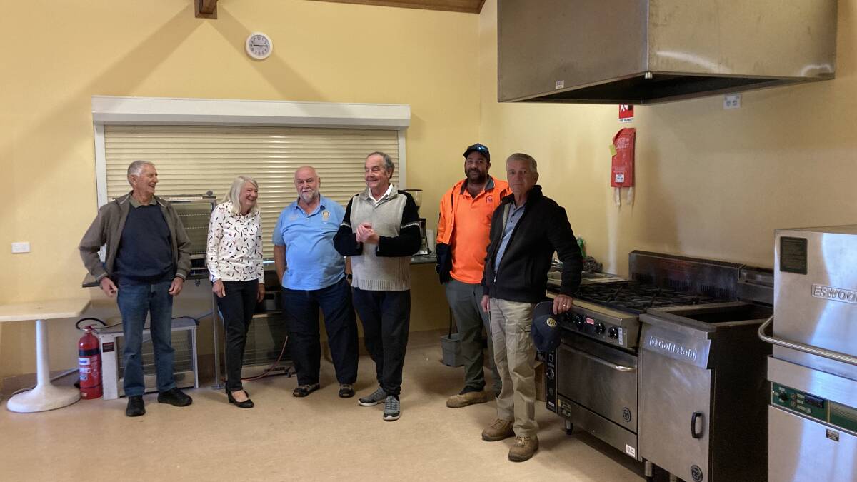 Members of the Eurobodalla Show Society, Moruya Rotary and builder Mark Brown, in the newly renovated kitchen at Moruya Showground.