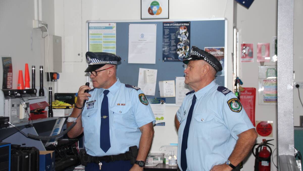 Sergeant Angus Duncombe makes the final radio call for Senior Constable Mark Dawes at Batemans Bay Police Station.