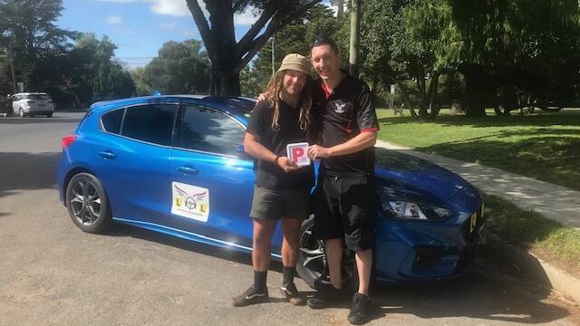 Sean Burgess with a client Billy Hatzis who recently passed his driver's test.