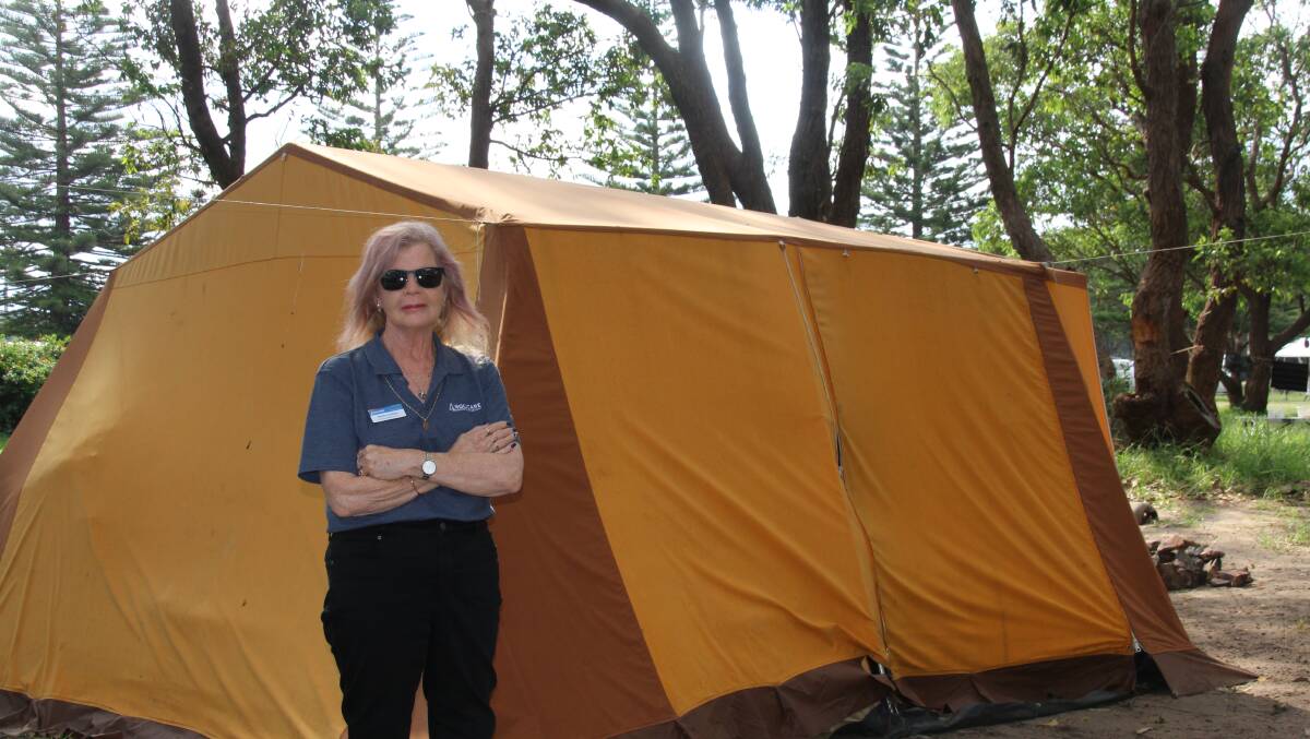 Anglicare's Emergency Relief Coordinator Pauline Sullivan stands in front of the tent of one of her clients near the Moruya Airport.