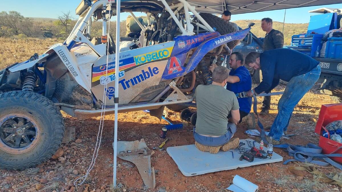 Matt Lavis and his team service the buggy.
