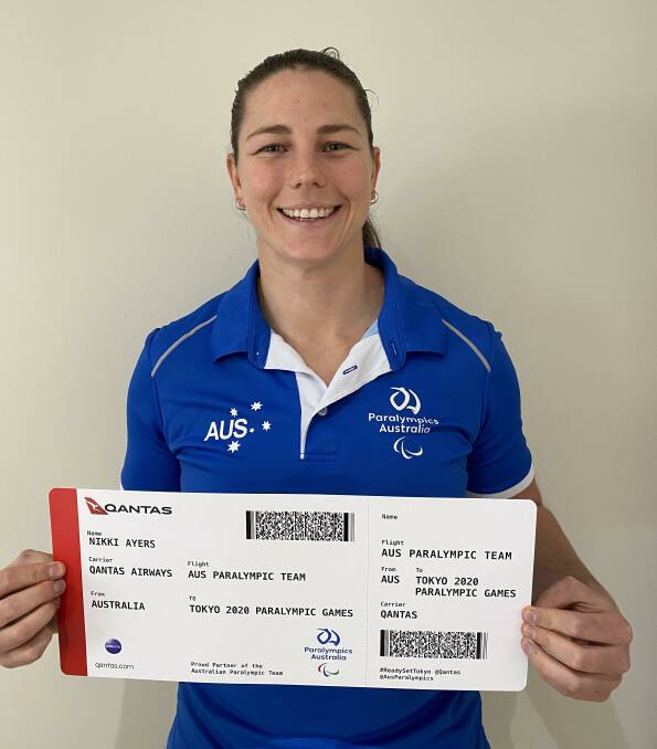 Nikki Ayers with her ticket to the Paralympics before her team finished fourth in the PR3 Mixed Coxed Fours.
