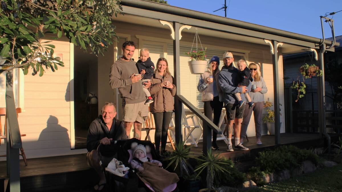 The Desaxe family in Tomakin watch the Anzac Day parade march down the main street from their front balcony with warm cups of coffee in hand.
