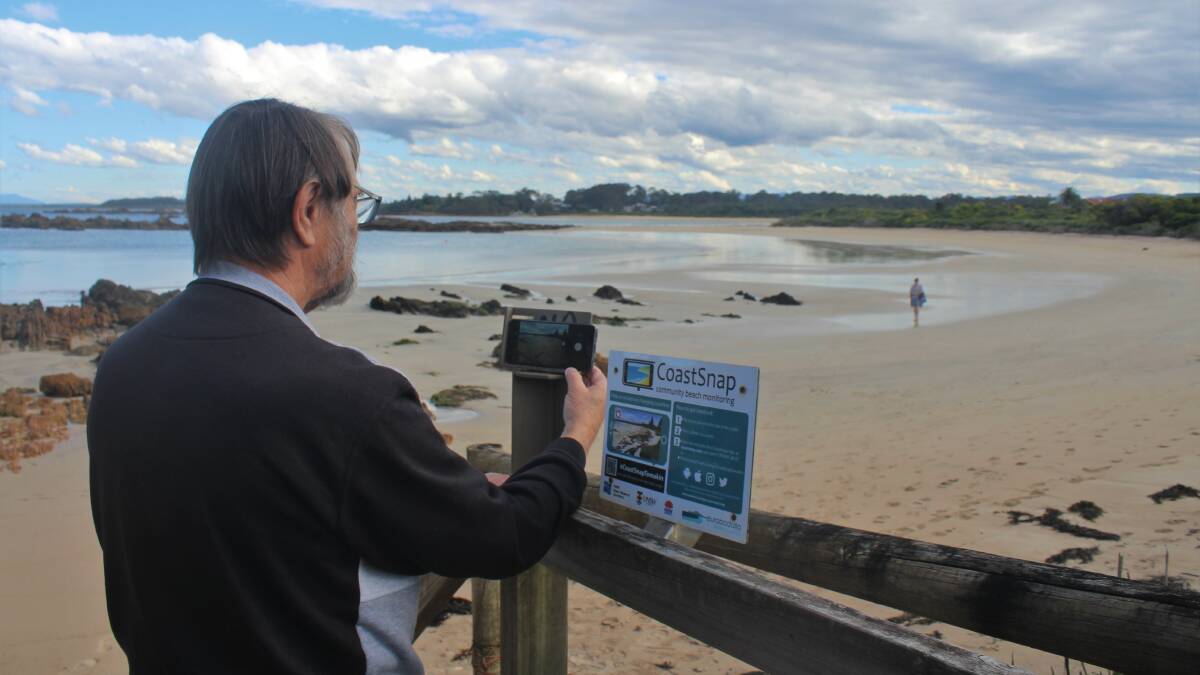 Tomakin's Charlie Bell taking a CoastSnap picture of Tomakin Cove, like he has 260 times since the station was introduced. Picture: James Tugwell