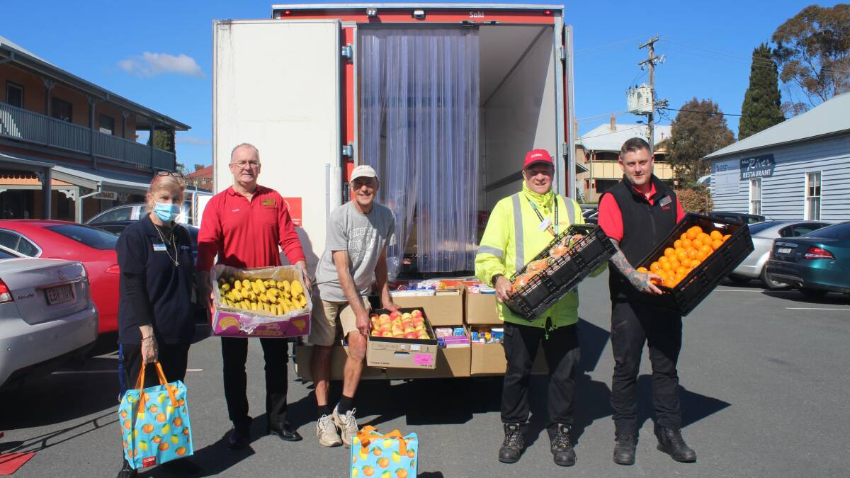 Coles workers delivering their donation to Anglicare staff and volunteers at Moruya. From left to right: Pauline Sullivan, John Appleby, Robert Avery, Wayne Dawson and Matt Gray. 