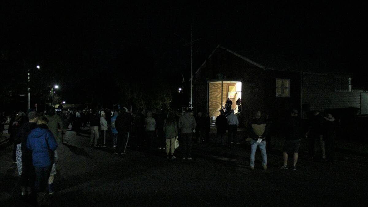 Crowds gather in Page Street Moruya in the early hours of ANZAC morning for the Dawn Service