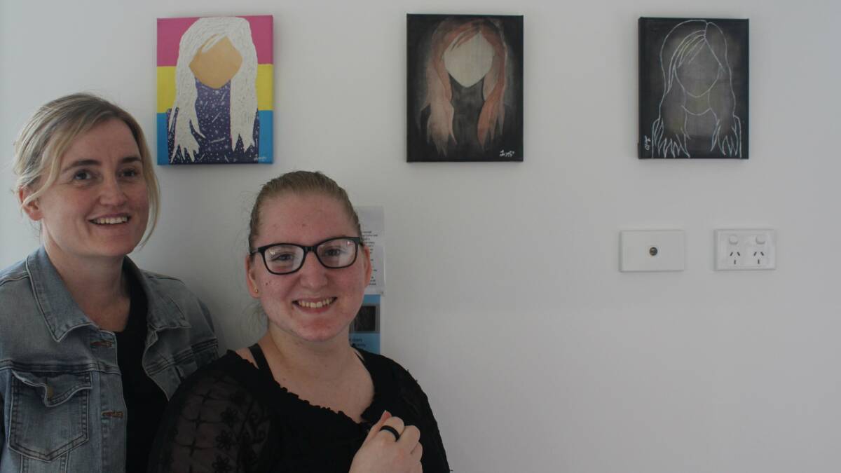 Ms Mulherin-Ogden (right) with her caseworker Krystal Tritton and the three part piece 'Leading with Vision'.