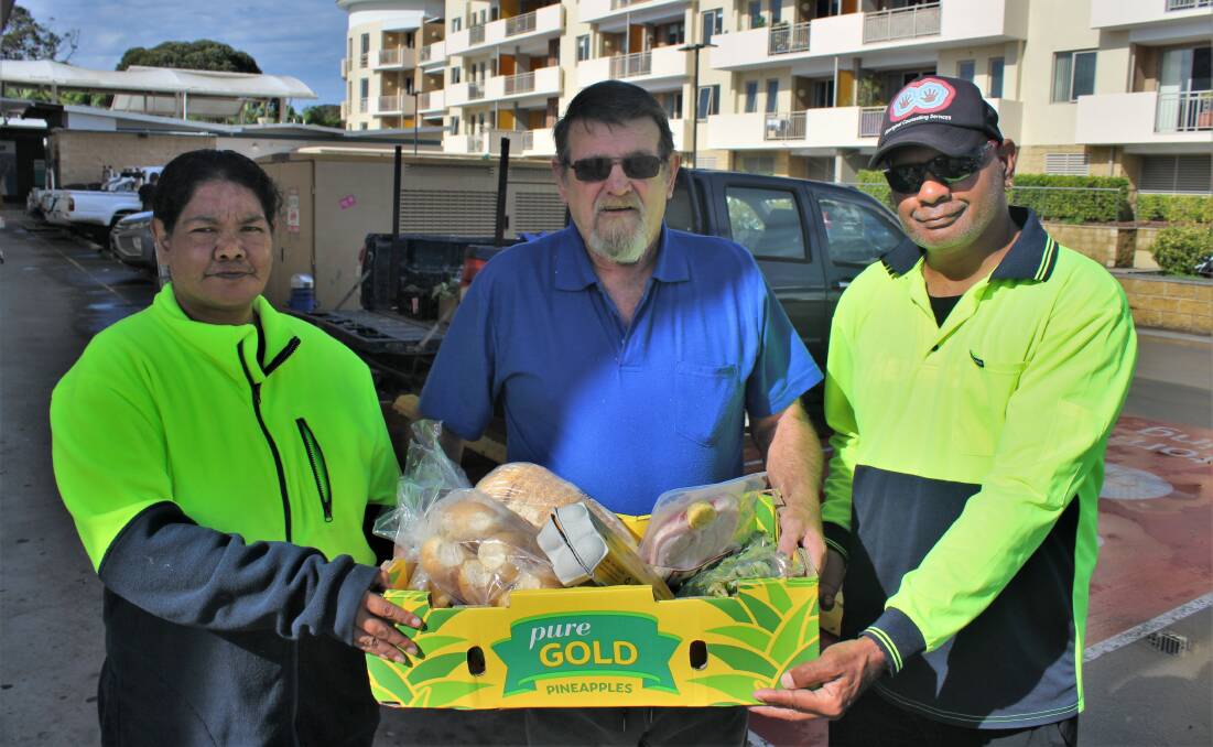 Volunteers Lisa Newman, Ray Howell and Vaughan Albert collecting the food before their weekly delivery run for South Coast Community Kitchen