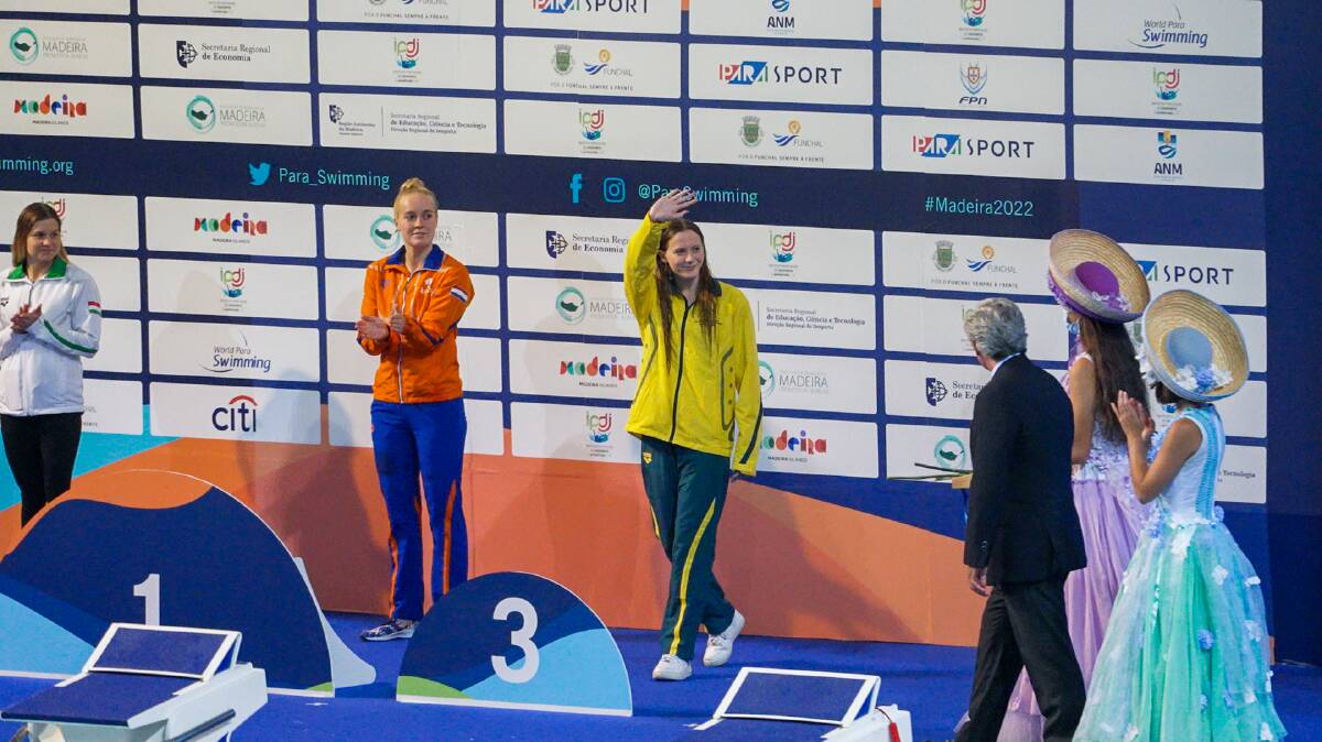GLORY: Jasmine Greenwood walks to the podium to be presented her bronze medal. Picture: Australian Dolphins Swim Team.