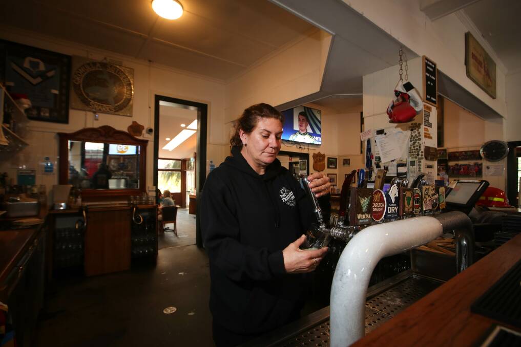 Pub manager Caroline Lenati pulls a beer in Kangaroo Valley. Picture:Sylvia Liber